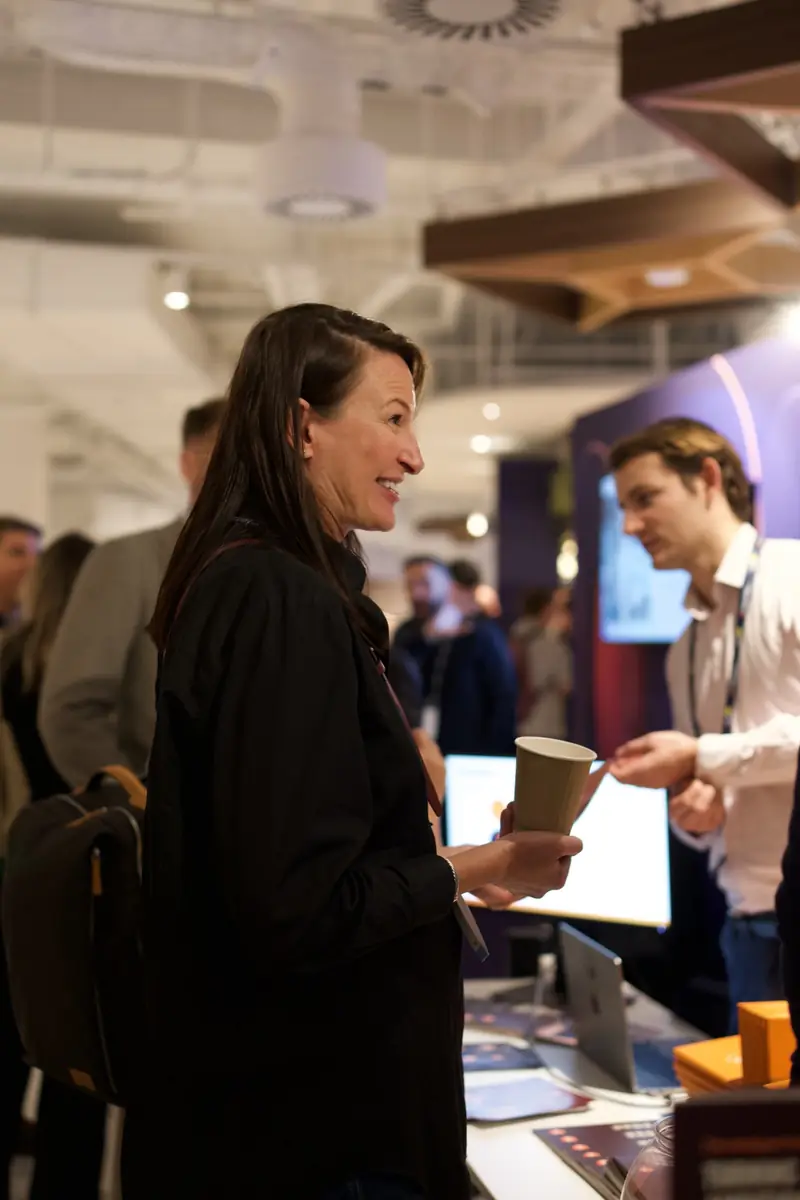 Two attendees in conversation in the Discovery Zone