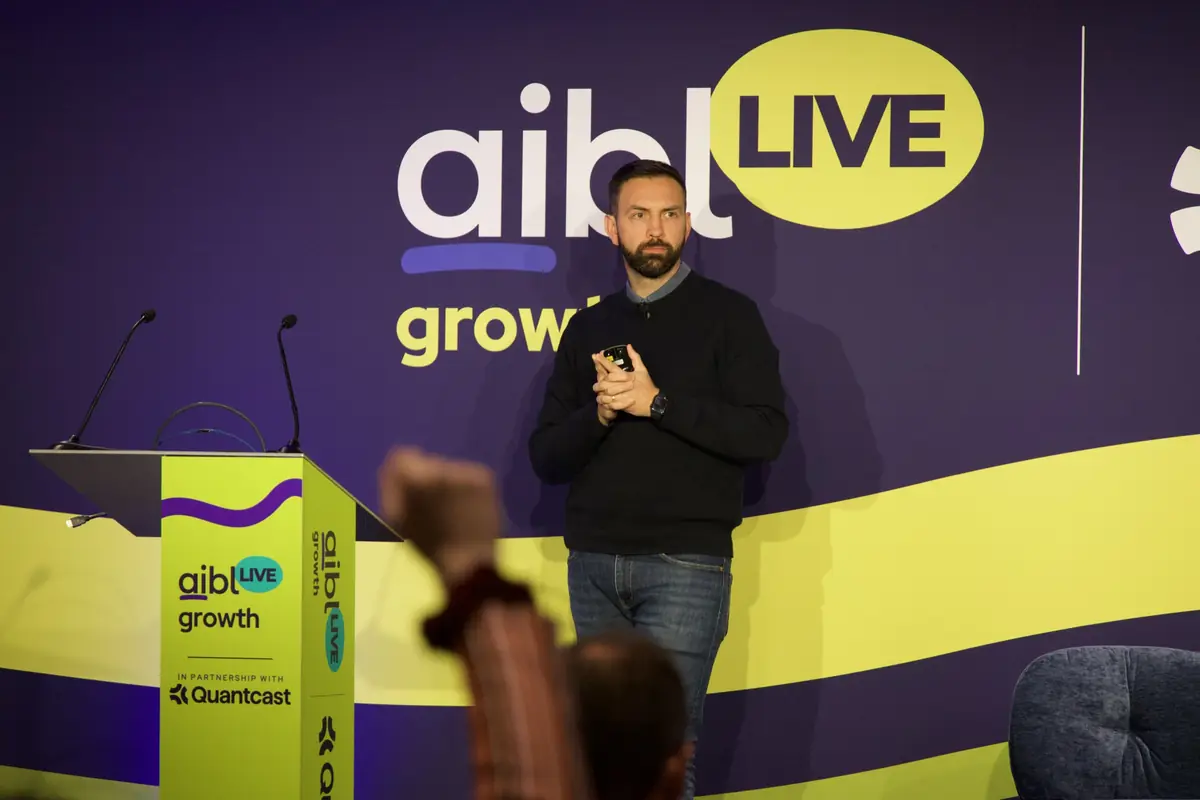 Speaker on stage in the Growth track room at aiblLIVE 2026