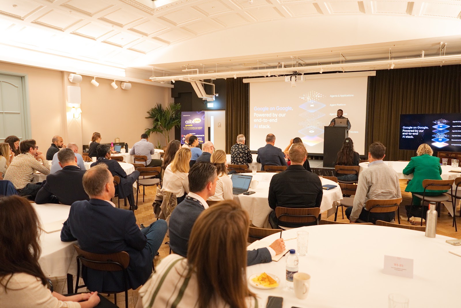 Business leaders at round tables during a growthLIVE Leadership Series session